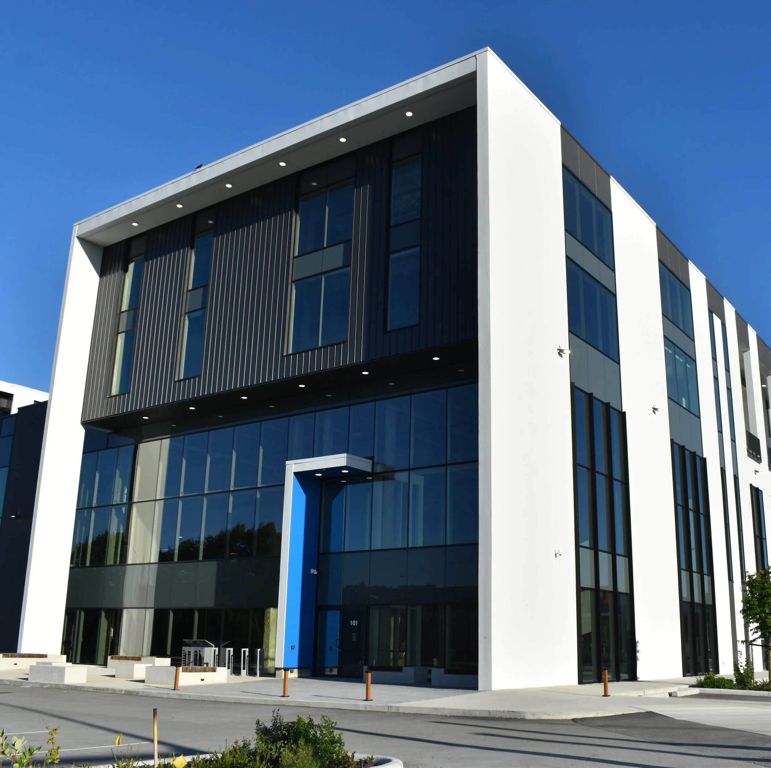Commercial exterior cladding installation with corrugated metal panels